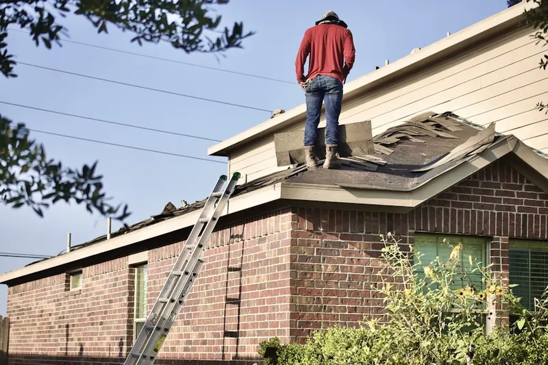 Professional roofer working on a residential roof in Meeks Bay